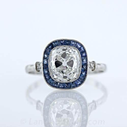 Cushion cut set with sapphire halo in art deco styled ring