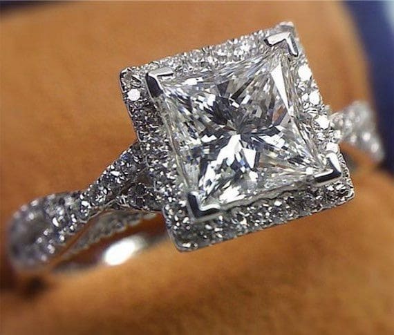 Princess cut diamond set with halo and crossover band. Creating a vintage appearance